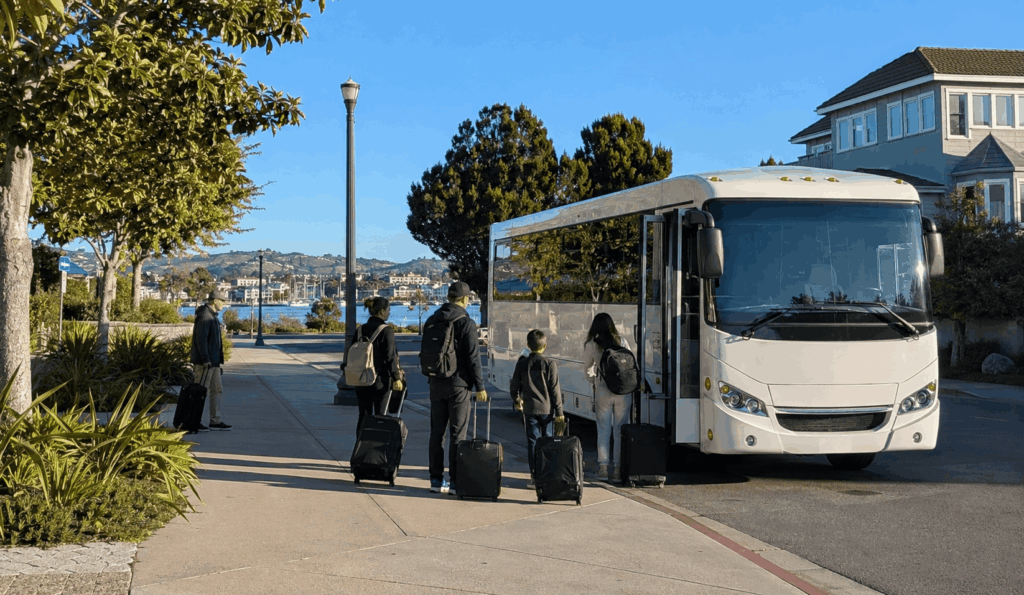 group boarding a minibus in alameda with luggage for a trip to oakland airport