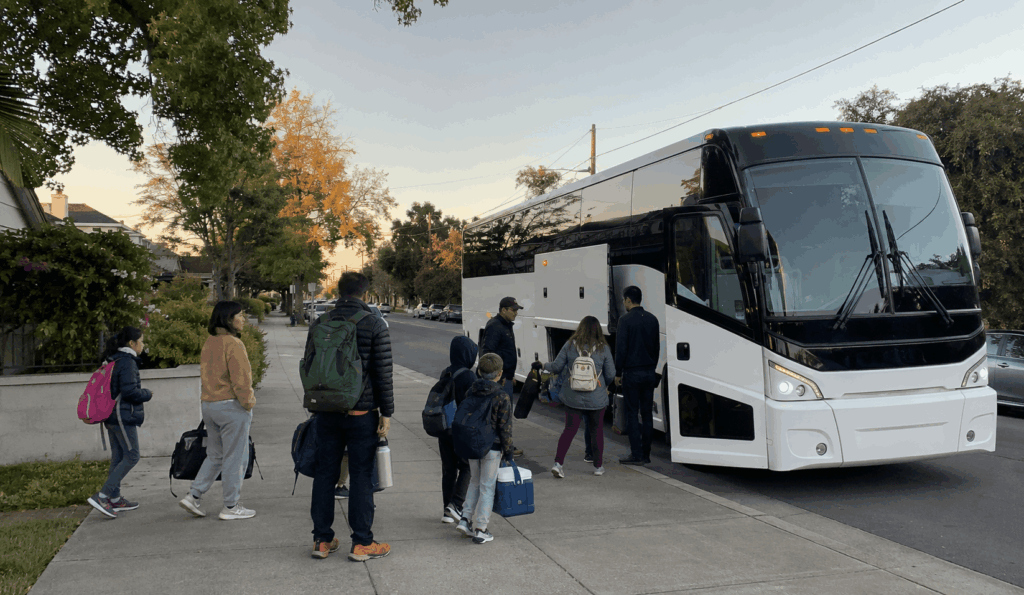 group boarding a charter bus in alameda early in the morning for a yosemite trip
