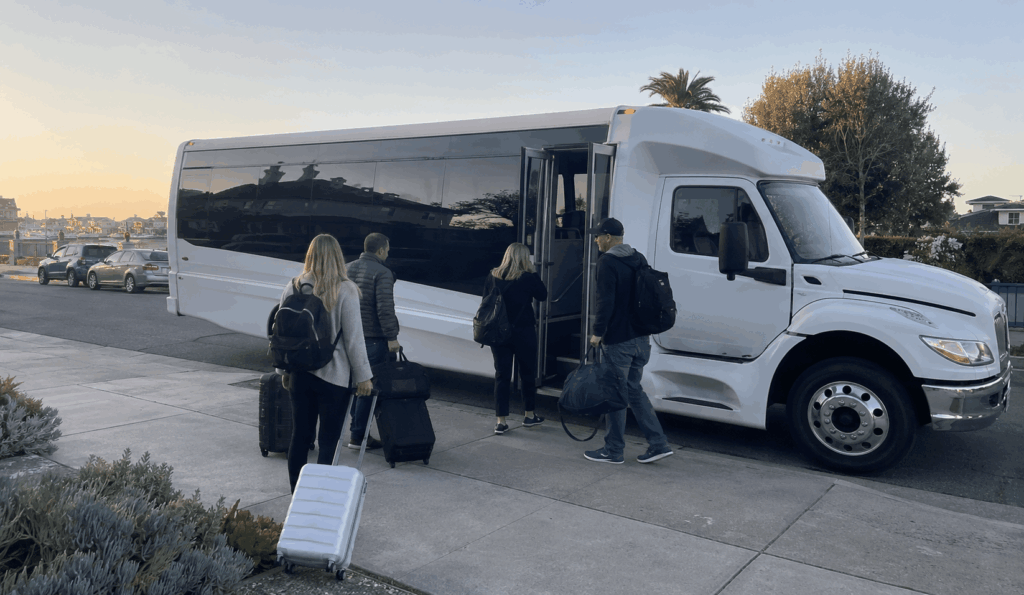 group boarding a charter bus in alameda before leaving for sfo airport
