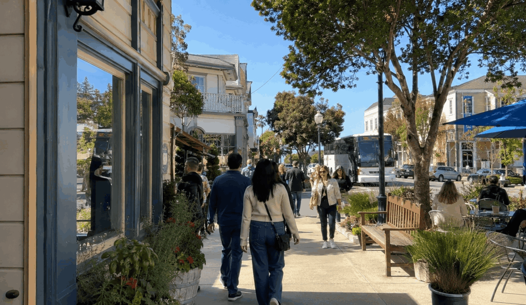 visitors exploring downtown half moon bay main street during a group trip from alameda