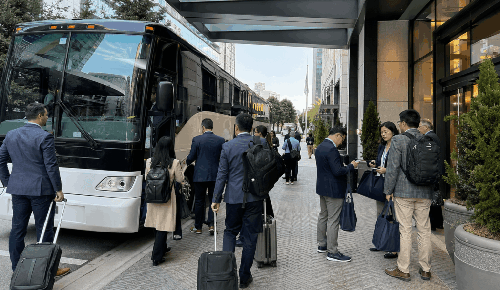 conference attendees boarding a charter shuttle outside a bay area hotel before heading to moscone center