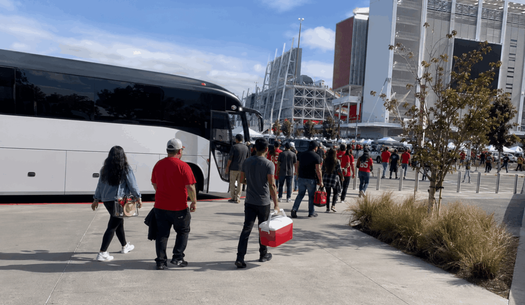 charter bus dropping off a group near levi’s stadium in santa clara for a game-day trip from alameda