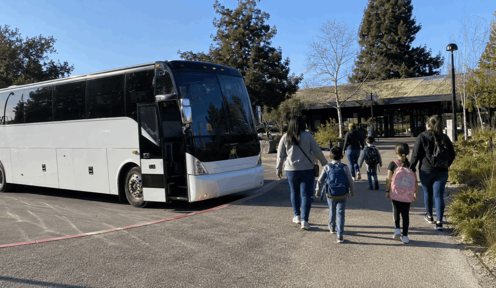 school group arriving by bus near the california academy of sciences in san francisco for a field trip