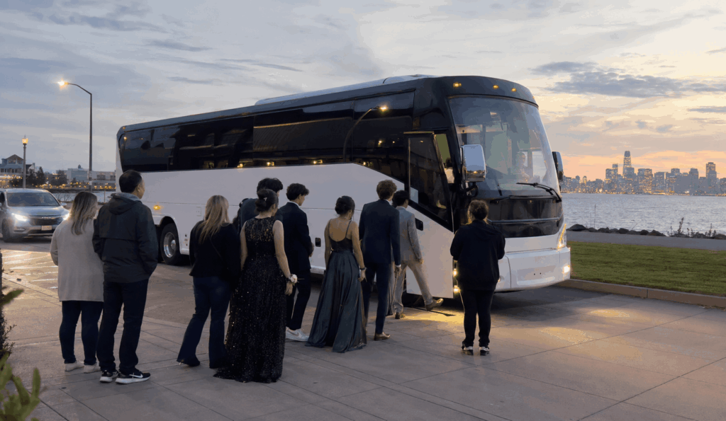 party bus picking up a prom group near the alameda waterfront in the bay area at sunset