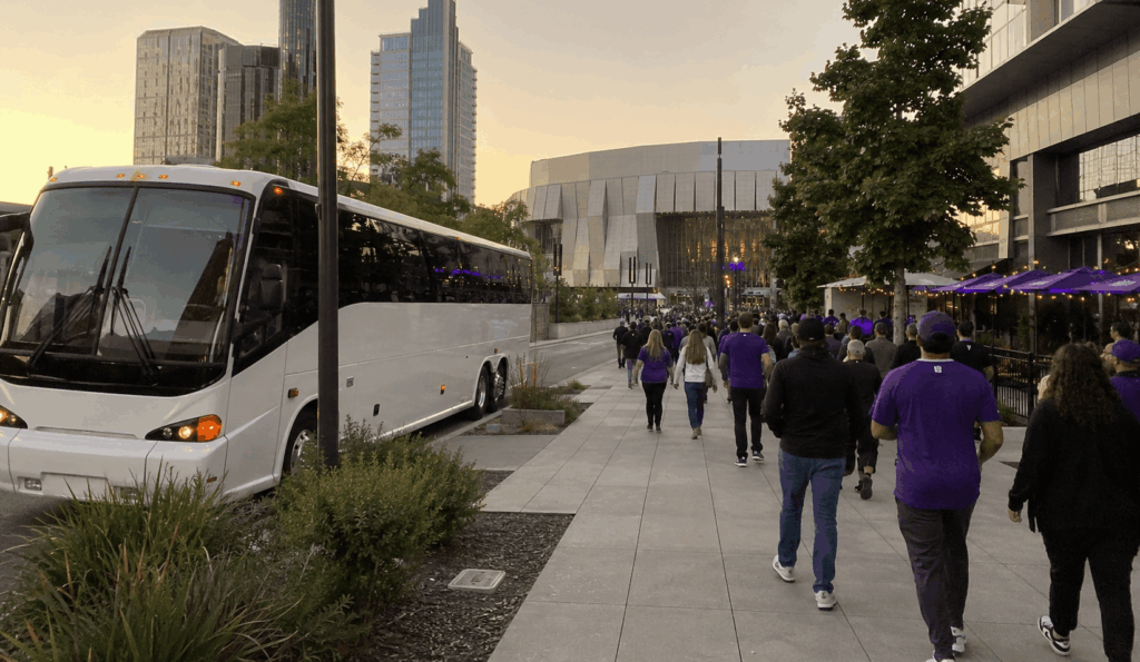charter bus dropping off a group near golden 1 center in downtown sacramento before a sacramento kings game