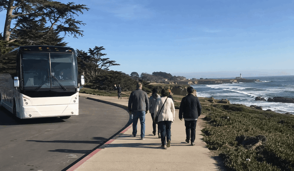 charter bus group visiting the santa cruz coast near west cliff drive after a boardwalk trip
