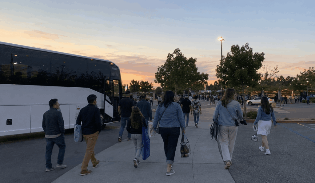 charter bus waiting near shoreline amphitheatre after a concert while guests avoid the parking lot exit crawl