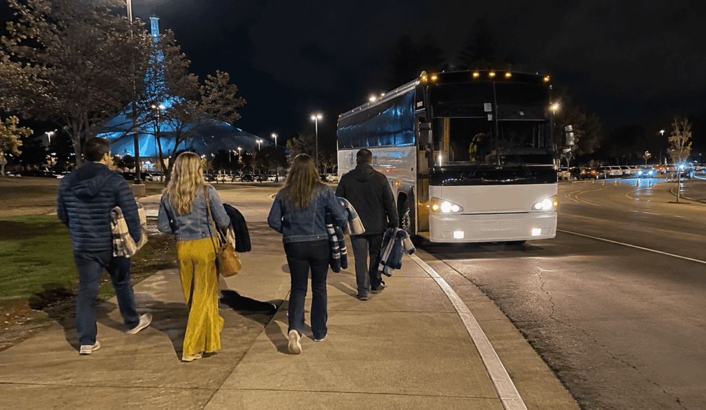 charter bus waiting near shoreline amphitheatre after a concert while guests avoid the parking lot exit crawl
