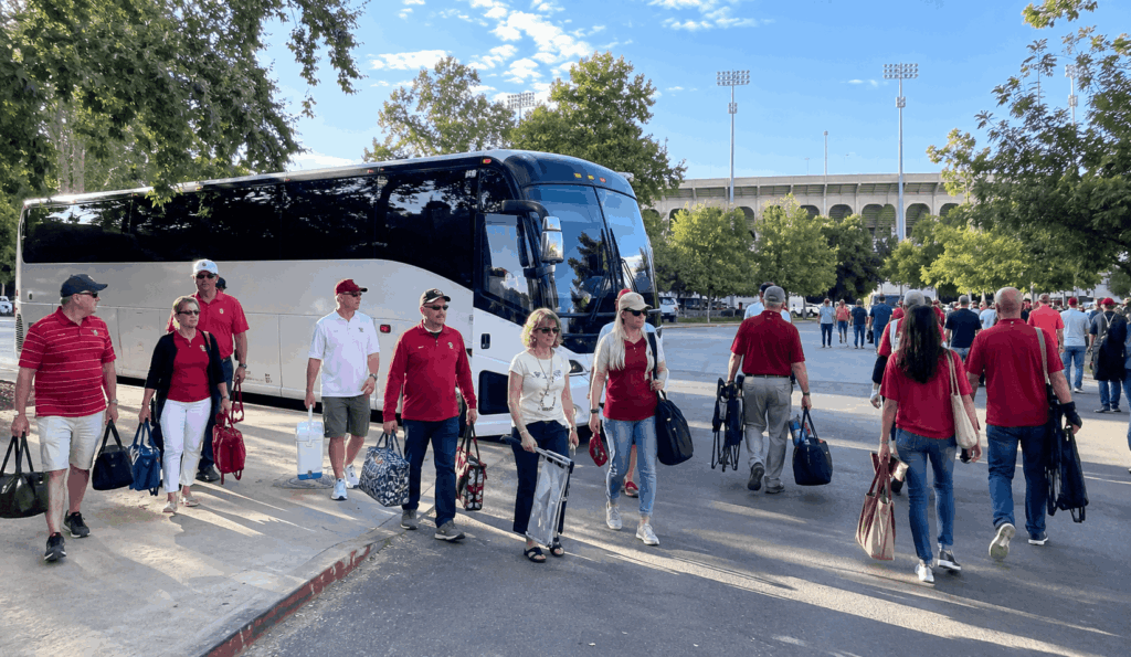 football fans boarding a charter bus after a college football game in the bay area